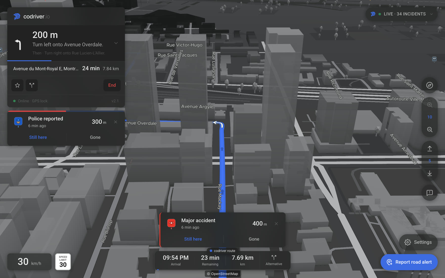 The codriver app on a Tesla screen at night in downtown Montreal: a card names a police report a few hundred metres ahead, with Still here and Gone buttons, above the route running between the buildings.